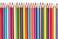 Color pencils laid out in a row on a white background Royalty Free Stock Photo