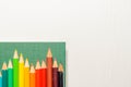 Color pencils, notebook on white background Royalty Free Stock Photo