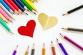 Color pencils and paper heart shape.