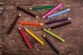 Color pencils scattered on wood background Royalty Free Stock Photo