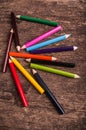 Color pencils scattered on wood background Royalty Free Stock Photo