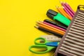 Color pencils in a school pencil case on a bright paper yellow background. Office tools. education Royalty Free Stock Photo