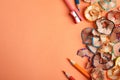 Color pencils, sharpener and shavings on orange, flat lay. Space for text Royalty Free Stock Photo