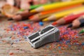 Color pencils, sharpener and shavings on table, closeup Royalty Free Stock Photo