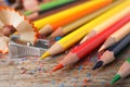 Color pencils, sharpener and shavings on table, closeup Royalty Free Stock Photo