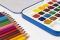 Color pencils and watercolor paints, isolated on a white background with copy space. Office, education concept. Work table, work Royalty Free Stock Photo