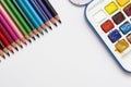 Color pencils and watercolor paints, isolated on a white background with copy space. Office, education concept. Work table, work Royalty Free Stock Photo