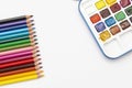 Color pencils and watercolor paints, isolated on a white background with copy space. Office, education concept. Work table, work Royalty Free Stock Photo