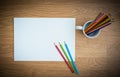 Color pencils in white coffee cup and white paper Royalty Free Stock Photo