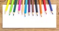 Color Pencils and white paper on wooden Royalty Free Stock Photo