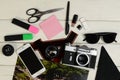 The color photo, the camera, markers, sticker, photoaccessories, shots of a film, flash card of memory and scissors on a table