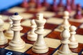 Color photo of chess Board and chess pieces, wooden chess pieces on the chessboard. White Queen and King in the foreground is a So Royalty Free Stock Photo