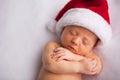 Christmas Newborn Baby Wearing Santa Hat and Sleeping Royalty Free Stock Photo