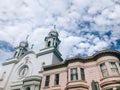 Spanish Style Church and Victorian Building With Dramatic Sky Background in San Francisco, California, United States Royalty Free Stock Photo