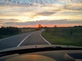 Photography of View on road and sunset from front car window Royalty Free Stock Photo