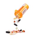 Color pills falling out of plastic yellow bottle Royalty Free Stock Photo