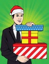 Color pop art comic style illustration. The man in the hat of Santa Claus is holding boxes with gifts. Businessman in a sui