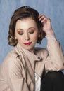 Portrait of beautiful woman dressed in vintage clothing wearing a retro hairstyle