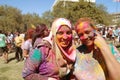 Color powder on two smiling ladies Spring Festival