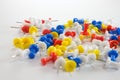 Color push pins red, yellow, white, and blue group on white background Royalty Free Stock Photo