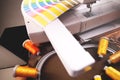 color selection process for an embroidery project with professional color fan positioned at a modern embroidery machine