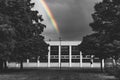Color selective rainbow behind a socialist abandoned house Royalty Free Stock Photo