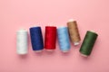 Color sewing threads on pink background Royalty Free Stock Photo