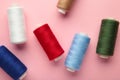 Color sewing threads on pink background Royalty Free Stock Photo