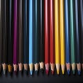 Color spectrum: a row of colored pencils on a black background Royalty Free Stock Photo