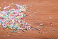 Color sprinkling. Sugar sprinkle, decoration for cake and bakery, a lot of sprinkles in a bucket on wooden background