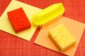 Color synthetic sponges, microfiber napkins and brush for cleaning on bamboo