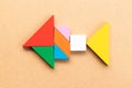 Color tangram in fish shape on wood background Royalty Free Stock Photo