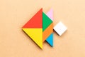 Color tangram in fish shape on wood background Royalty Free Stock Photo