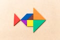Color tangram in fish shape on wood background Royalty Free Stock Photo