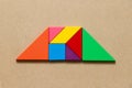 Color tangram in trapezoid shape on wood background