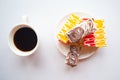 Color tasty glazed cakes and coffee cup on the plate