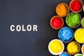 color text with different types holi color powder bowl black background. High quality photo