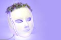 Color therapy mask glowing light purple, flowers