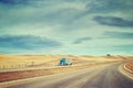 Color toned picture of American highway landscape with semi trailer truck