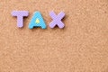 Color toy foam alphabet in word tax on cork board background Royalty Free Stock Photo
