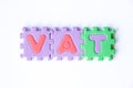 Color toy foam alphabet in word VAT & x28;Abberviation of Value added tax& x29; on white background Royalty Free Stock Photo