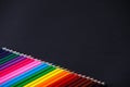 Color wooden bright pencils shades range on a dark background
