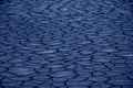 Color of the year 2020: Classic Blue. Cracked dry brown earth. Royalty Free Stock Photo