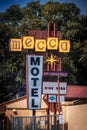 Colorado Springs USA Retro Vintage Hotel sign that says No vacancy for Mecca Motel against green trees