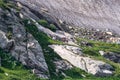 Hikers walk near St. Mary`s Glacier on a hike in the summer sunshine