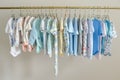 colorcoordinated baby outfits on closet rods Royalty Free Stock Photo