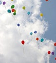 colored balloons fly into the sky with clouds Royalty Free Stock Photo