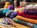 Colored balls of wool on the table with knitting needles