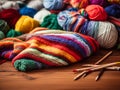 Colored balls of wool on the table with knitting needles