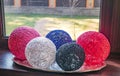 Colored balls of wound thread on a windowsill